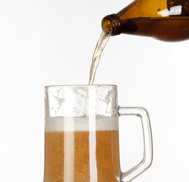 Putting beer in a glass jar - 写真・画像