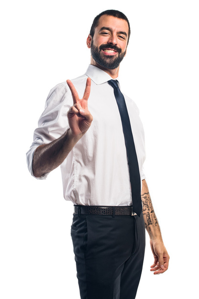 Businessman doing victory gesture - Photo, Image