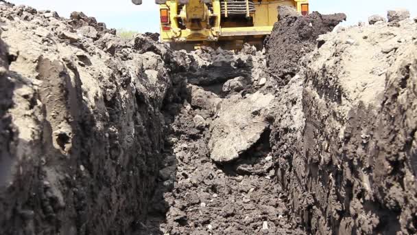 Excavator is excavating a ditch - Footage, Video