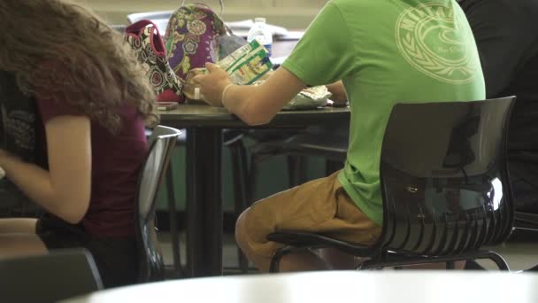 Students working at their desks in a classroom - Footage, Video