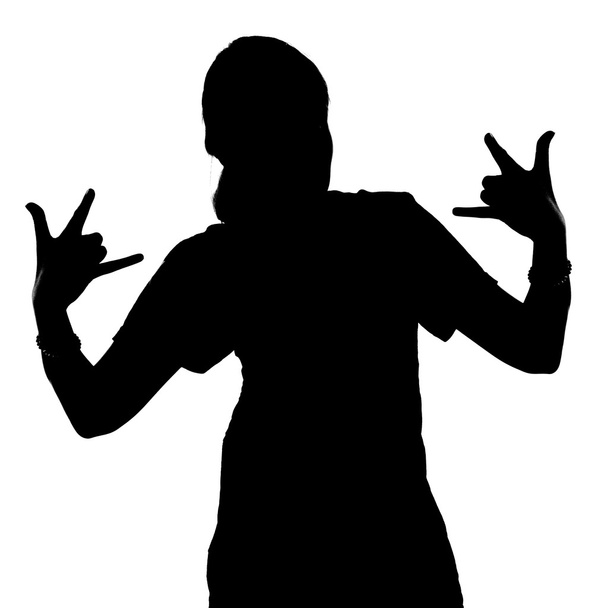Silhouette of teenage girl with arms Giving The Rock and Roll Sign on white background
 - Фото, изображение
