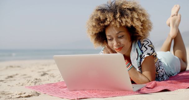 woman with laptop on summer beach - 写真・画像