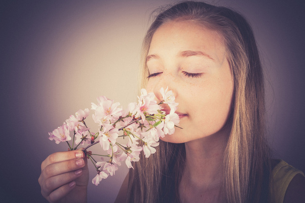 Lány szippantás cseresznye virágok, gabona hatása - Fotó, kép