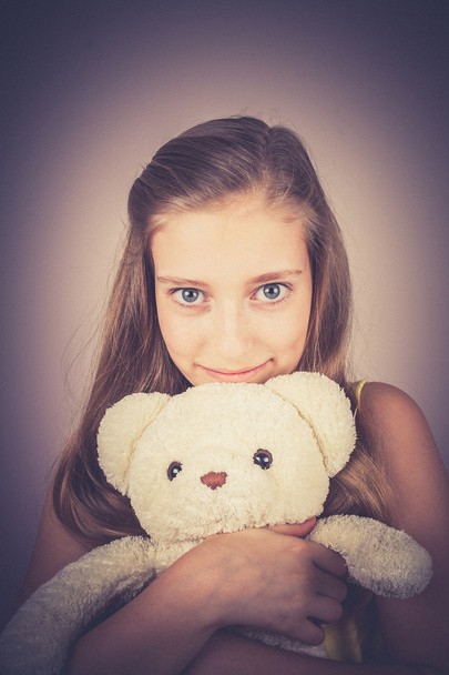 Teenage girl with teddy bear, grain effect - Photo, Image