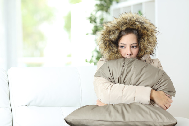 Woman warmly clothed in a cold home - Фото, изображение