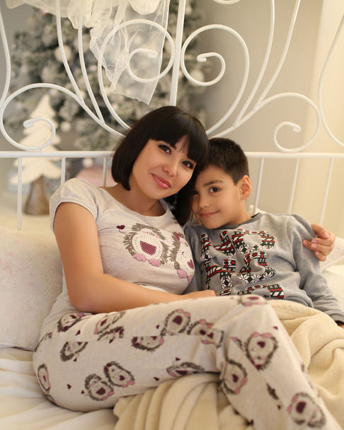 beautiful mother with short dark hair and her little son  - Фото, зображення