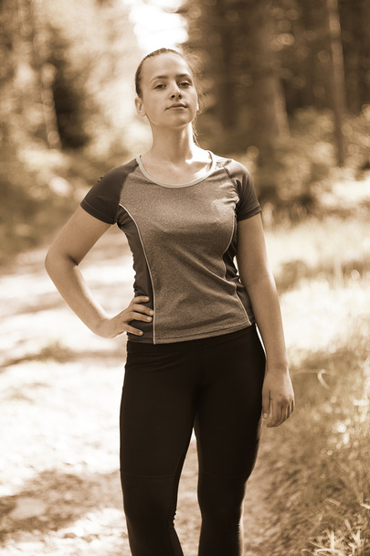 Attractive fit woman in sportswear training outdoors, female ath - Photo, image
