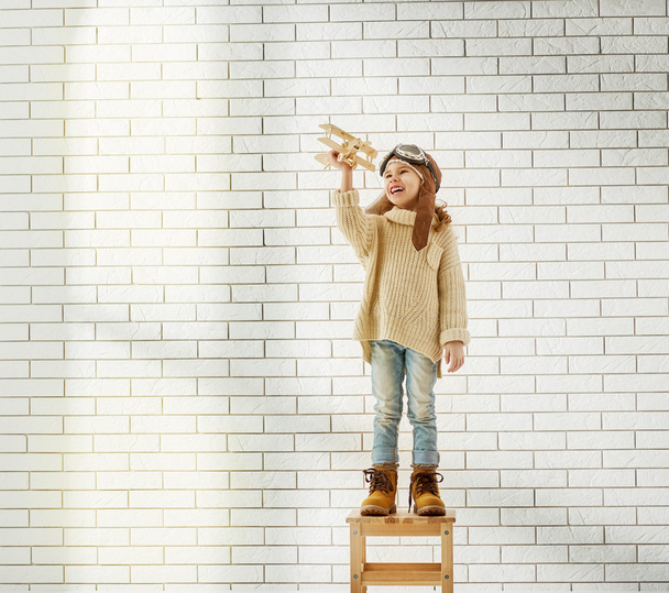 girl playing with toy airplane - Фото, зображення