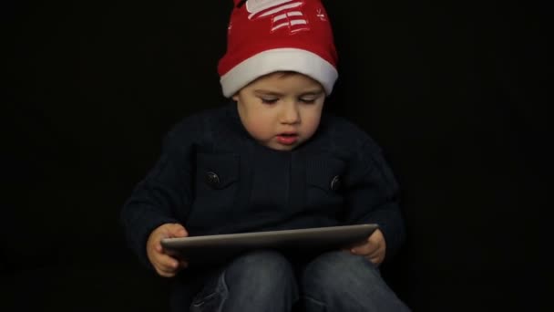 Little boy have fun holding a tablet pc - Кадри, відео