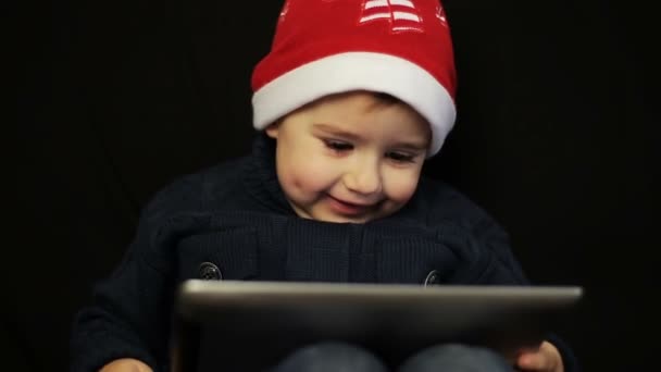 Little boy have fun holding a tablet pc - Video