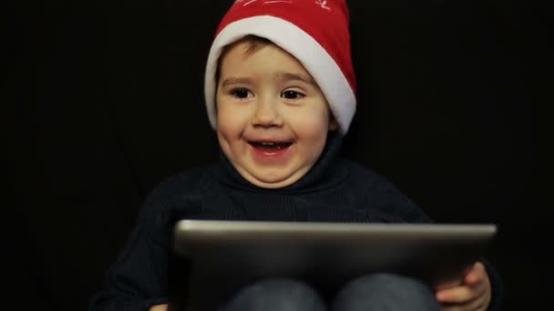 Little boy have fun holding a tablet pc - Záběry, video