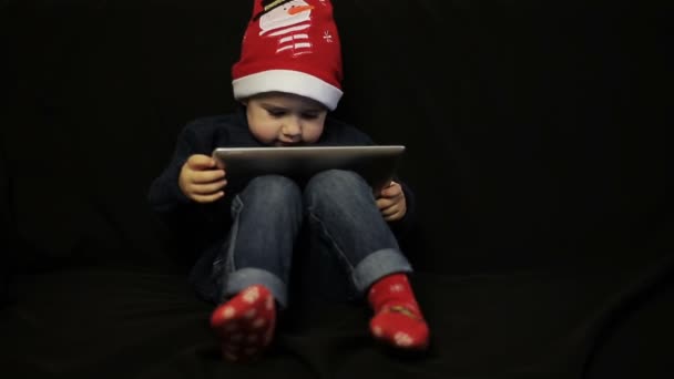 Little boy have fun holding a tablet pc - Video
