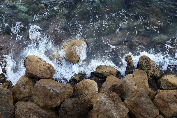 Waves lapping on the rocks - Photo, Image