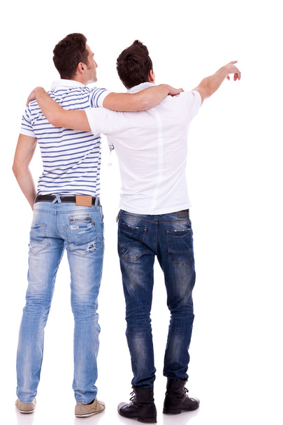 Two young men pointing at somethin - Photo, Image