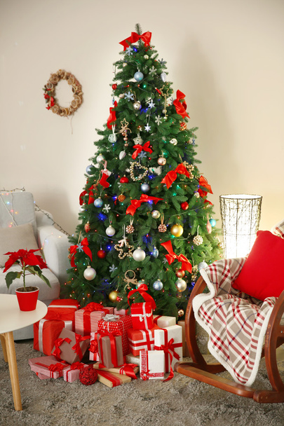 Christmas fir tree with gifts in living room - Fotó, kép
