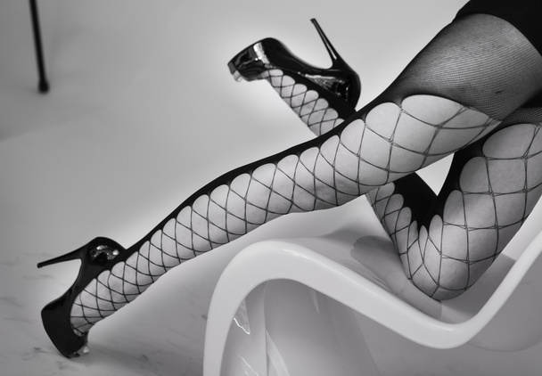 female model legs in fishnet hosiery - Zdjęcie, obraz