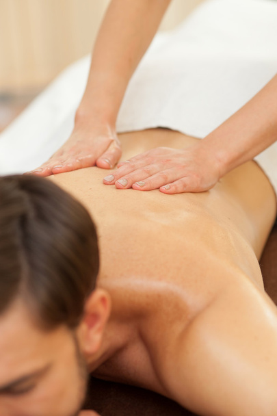 Experienced female therapist is massaging her customer - Фото, зображення