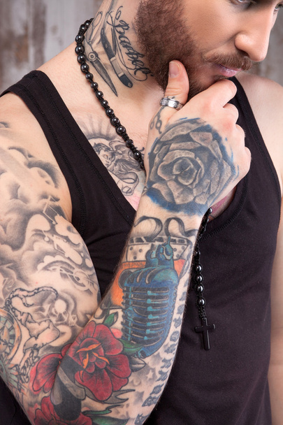 Cheerful tattooed man is making serious decision - Фото, изображение