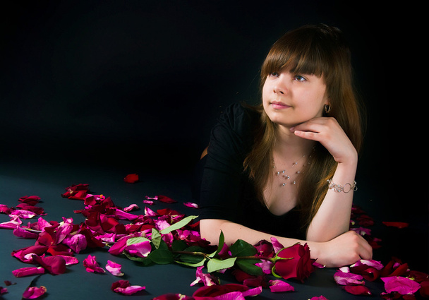 Girl with a rose on a black background - Photo, image
