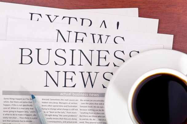 Business newspaper and cup of coffee - Foto, imagen
