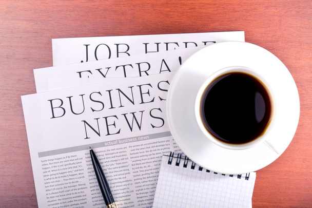 Business newspaper, notebook and cup of coffee - Фото, изображение