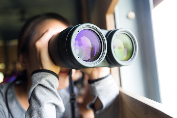 Asian woman using binoculars for birdwatching - Valokuva, kuva
