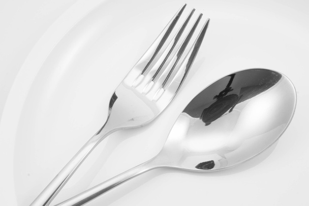 Fork and spoon on a plate with napkin - Zdjęcie, obraz