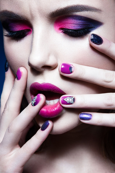 Beautiful girl with bright creative fashion makeup and colorful nail polish. Art beauty design. - Photo, Image