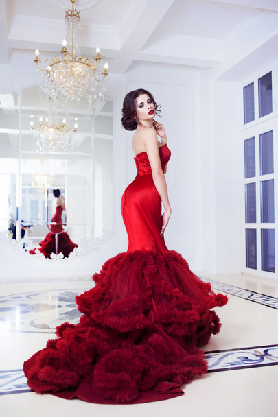 Beauty Brunette model woman in  evening red dress. Beautiful fashion luxury makeup and hairstyle,   full length - Fotó, kép