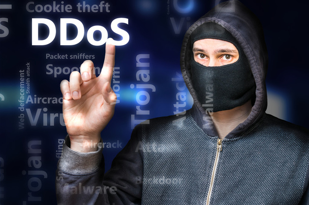 Masked anonymous hacker is pointing on DDoS Attack - Photo, Image