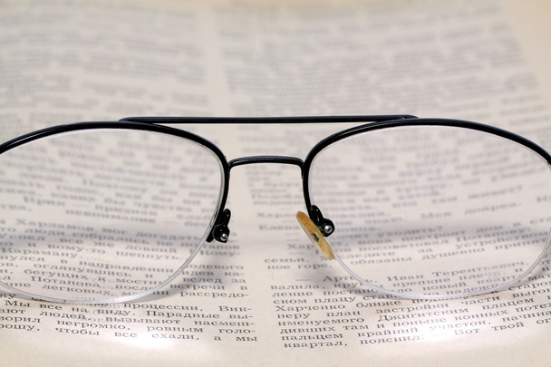 Spectacles on old book - 写真・画像