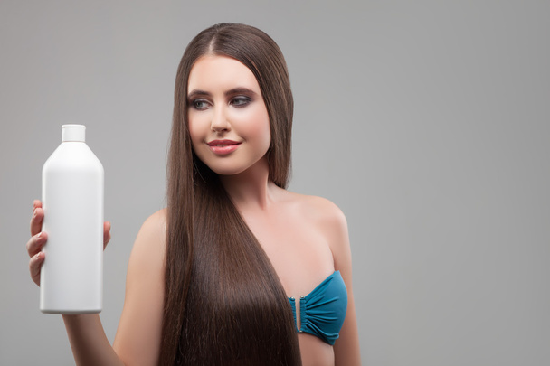 Cheerful healthy girl is presenting hair treatment - Photo, Image
