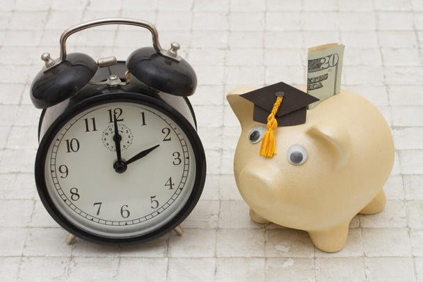Time to start saving for college, A piggy bank and alarm clock o - Photo, Image