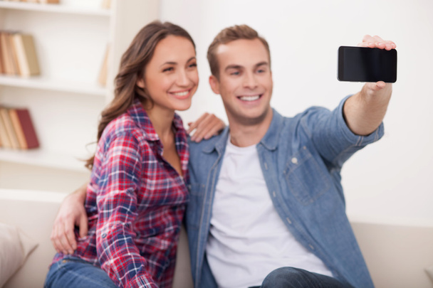 Attractive husband and wife are photographing themselves - Foto, Bild