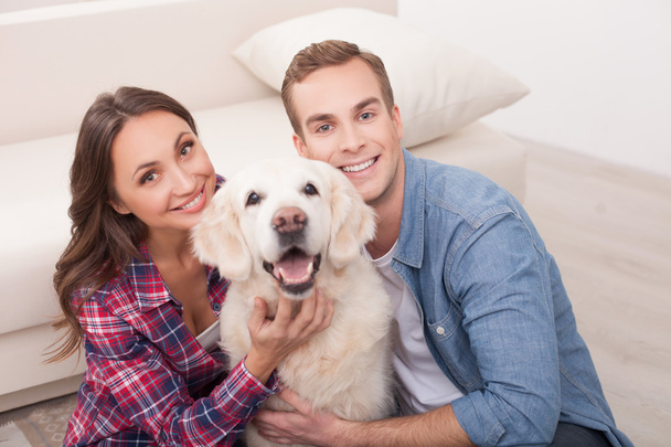 Attractive young married couple with cute pet - Fotoğraf, Görsel