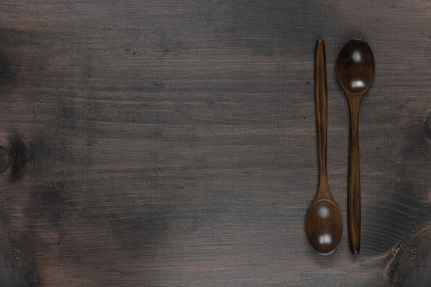 Wooden spoons on a dark background - Fotó, kép