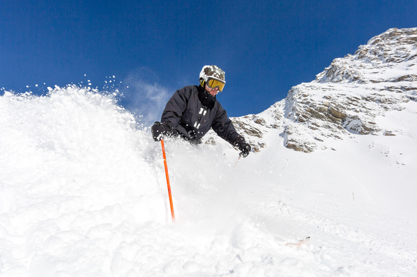 Skier skiing on ski slope - Photo, Image