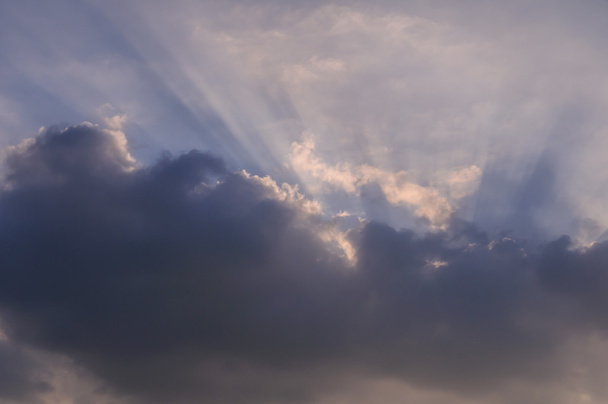 Rays of light shining through clouds, sunset - Photo, Image