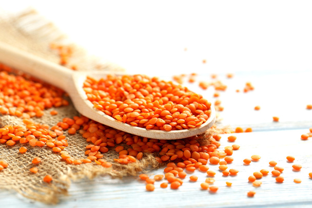 Red lentils in the wooden spoon - Foto, imagen
