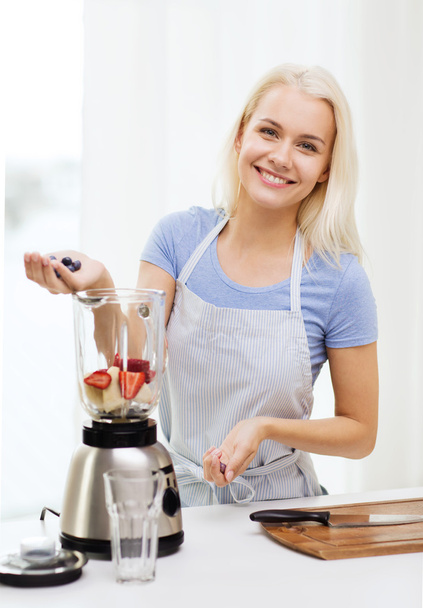 smiling woman with blender preparing shake at home - Fotografie, Obrázek