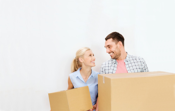 couple with delivery boxes moving to new home - 写真・画像