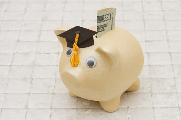 Time to start saving for college, A piggy bank and graduation ca - Photo, Image