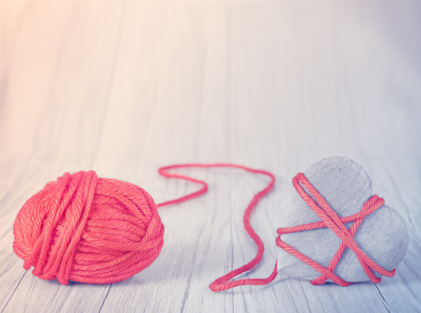Wooden heart tied with red yarn, concept picture - Photo, Image