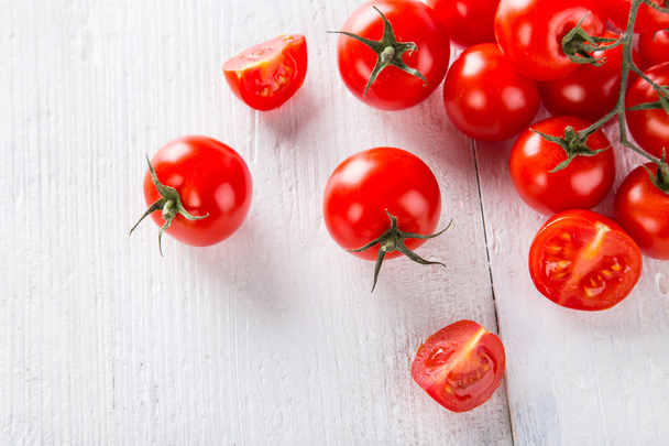 Fresh cherry tomatoes on a wooden table - Fotó, kép