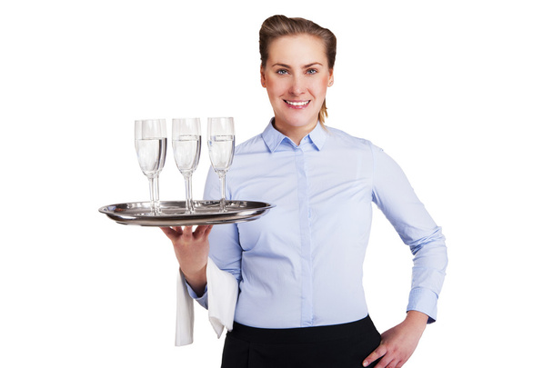 Woman in waiter uniform holding tray with glasses, smiling, isol - Photo, Image