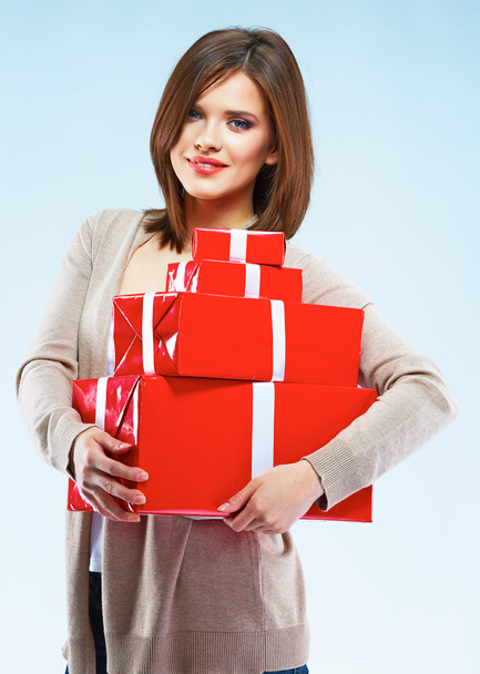 Woman holds red gift boxes - Фото, изображение