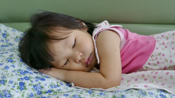 Χαριτωμένο κοριτσάκι που κοιμάται στον καναπέ-κρεβάτι - Πλάνα, βίντεο