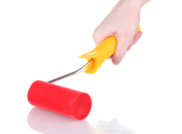 Bright paint roller in hand isolated on white - Fotó, kép