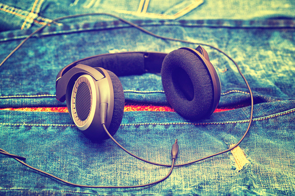 large wired headphones on the background of jeans - Photo, Image