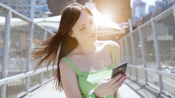 young woman using smart phone outdoors - Video, Çekim